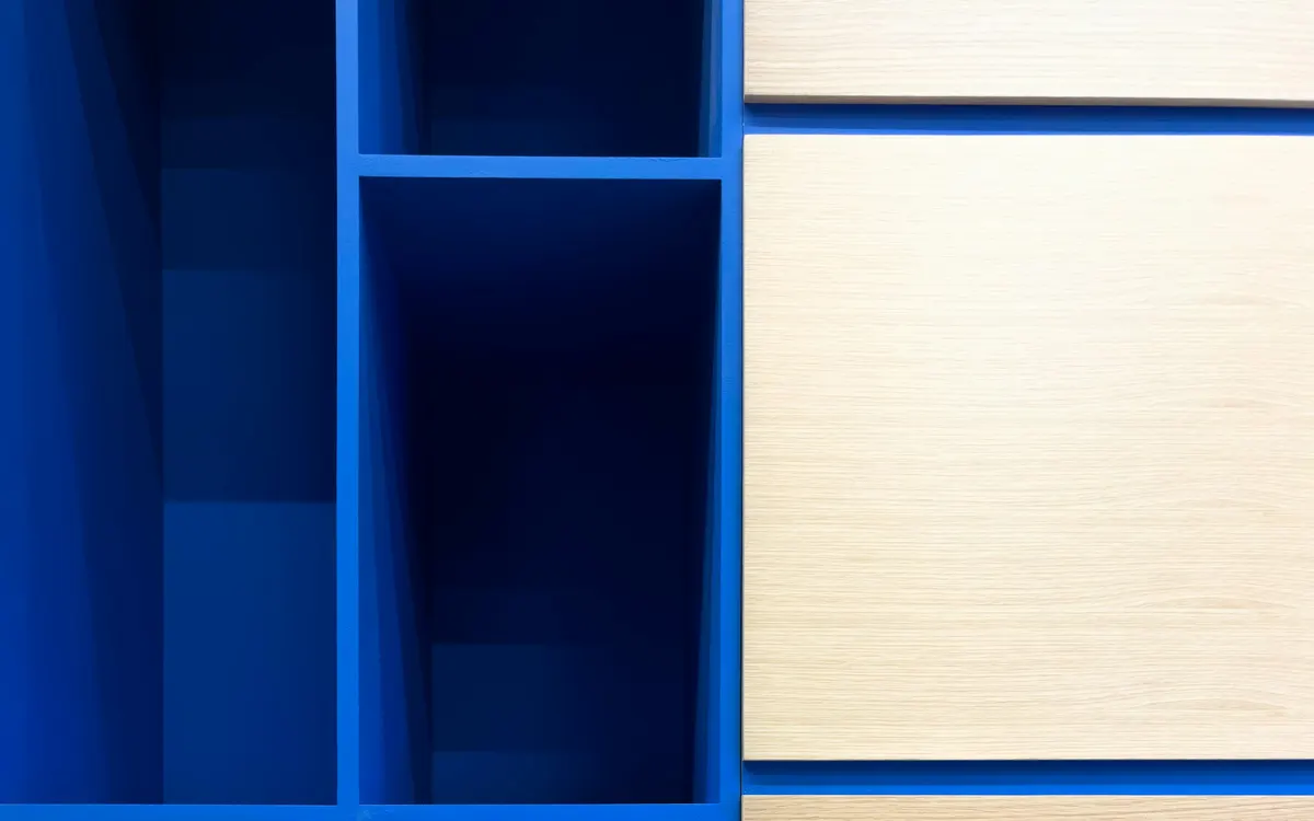 A modular cube shelving unit in blue and pale wood