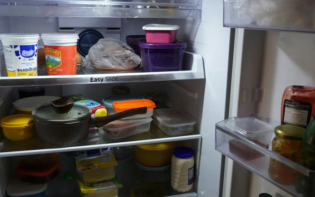 Open refrigerator with food and drinks visible on shelves
