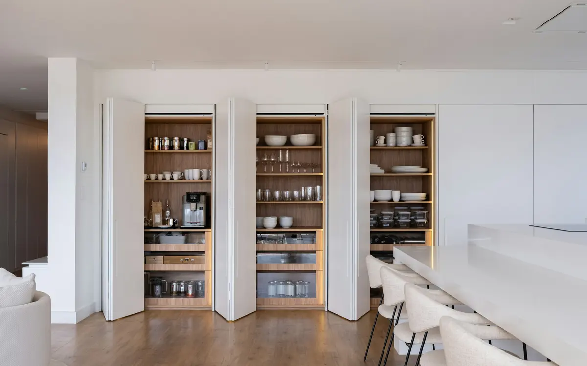 Kitchen pantry shelves stocked with jars, packets and bowls