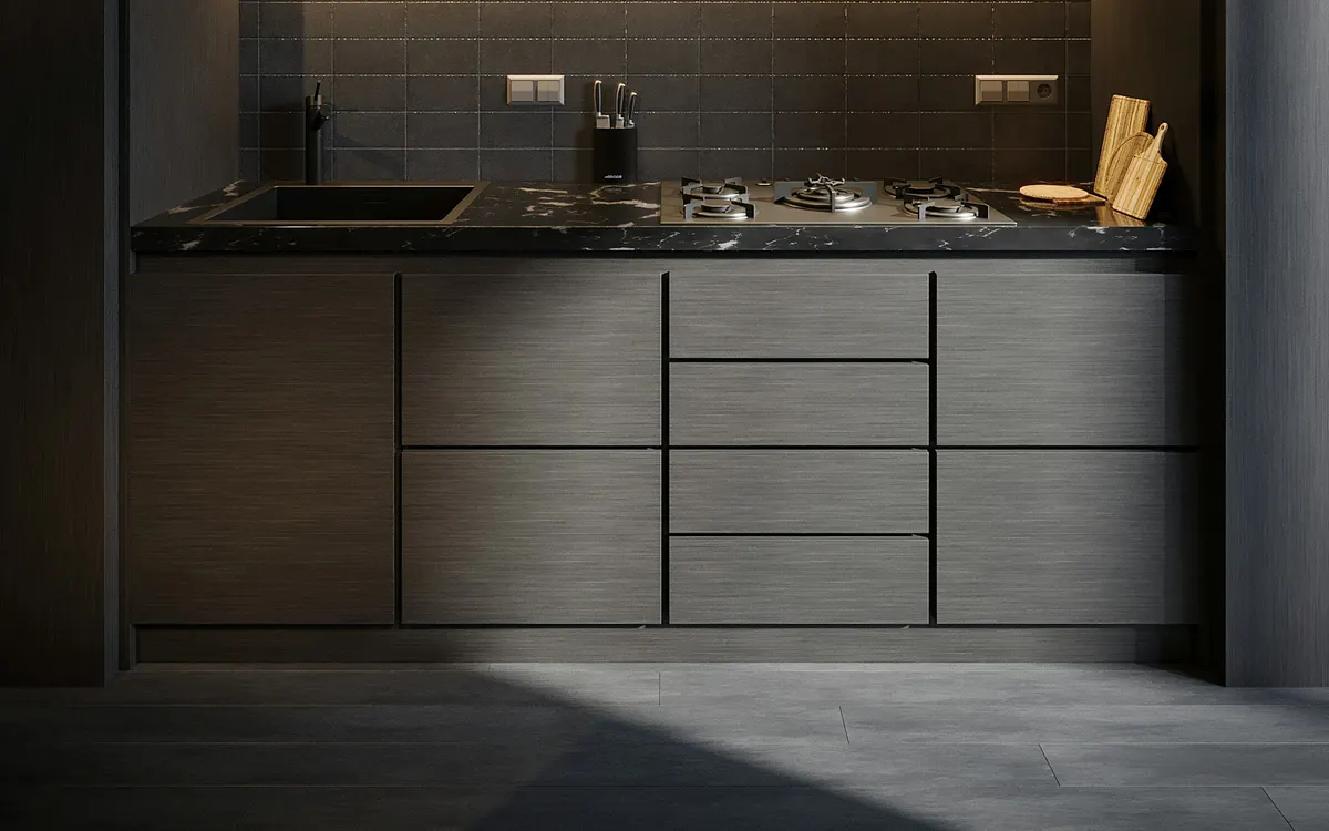 Dark kitchen base units and drawers under a worktop with a sink